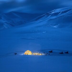 View of camp at night from dogsledding in Svalbard.