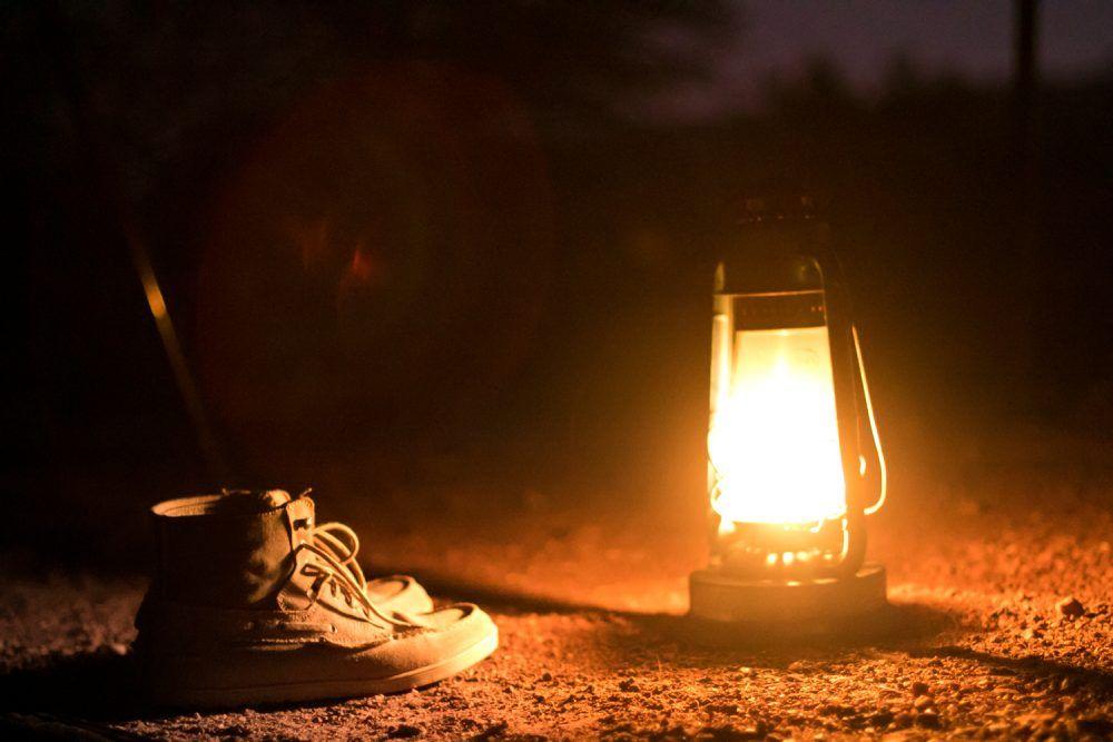 Closeup of shoes and lantern at Wilderness camp in Masai Mara.