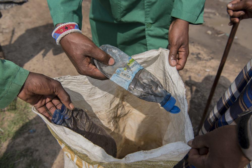 Picture of plastic bottle being properly recycled by locals Kenya.