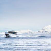 Basecamp Explorer Isfjord Expressen boat driving through arctic waters on Svalbard.
