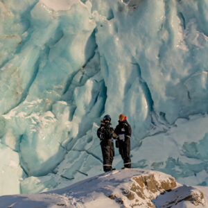 Persons in front of glacier